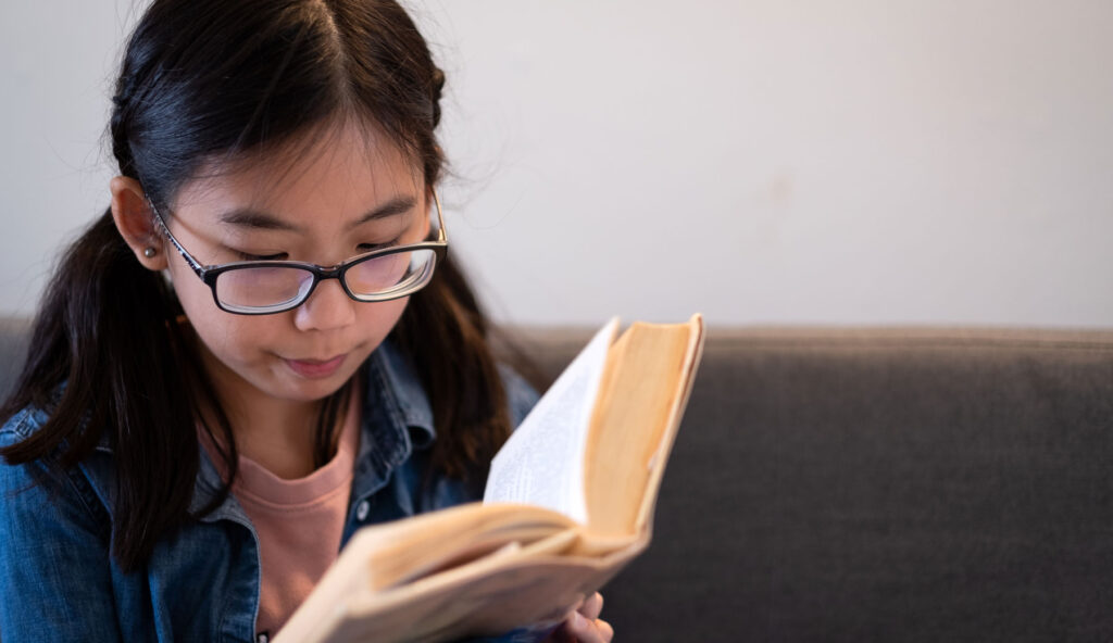 teen girl reading a book